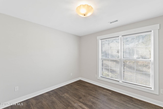 unfurnished room featuring dark hardwood / wood-style floors