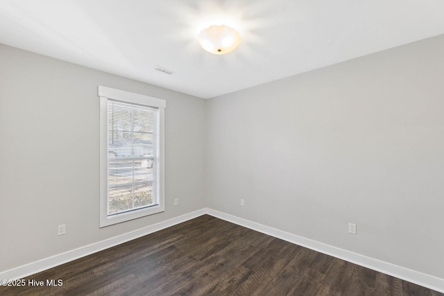 unfurnished room featuring dark hardwood / wood-style flooring