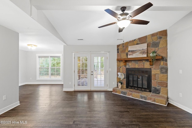 unfurnished living room with ceiling fan, dark hardwood / wood-style floors, lofted ceiling, a fireplace, and french doors