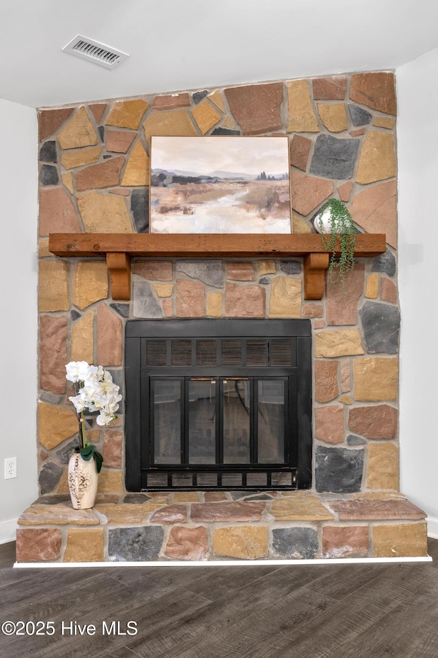 interior details with wood-type flooring and a fireplace