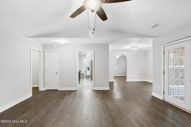 unfurnished living room featuring ceiling fan, lofted ceiling with beams, and dark wood-type flooring