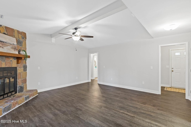 unfurnished living room with ceiling fan, vaulted ceiling with beams, dark hardwood / wood-style floors, and a stone fireplace