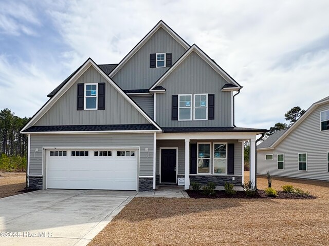 view of front facade featuring a garage and covered porch