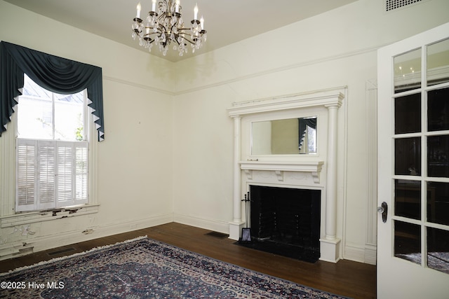 unfurnished room with dark hardwood / wood-style flooring and an inviting chandelier