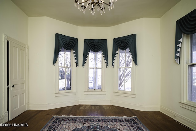 interior space featuring dark hardwood / wood-style floors and a notable chandelier