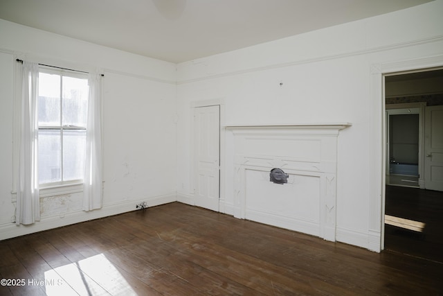 spare room with dark wood-type flooring