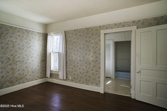 unfurnished room with dark hardwood / wood-style flooring