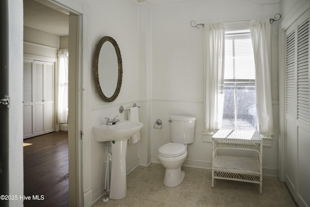 bathroom featuring toilet and tile patterned flooring