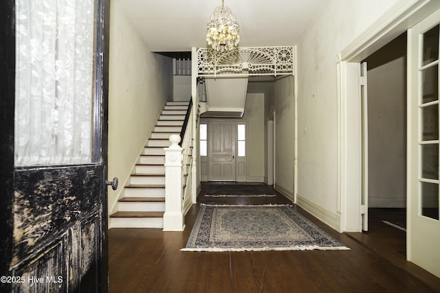 foyer featuring dark hardwood / wood-style floors and a chandelier