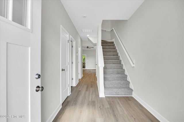 211 Lincoln Place Cir, Leland, NC 28451 - foyer entrance featuring light wood-style flooring, stairway, baseboards, and ceiling fan