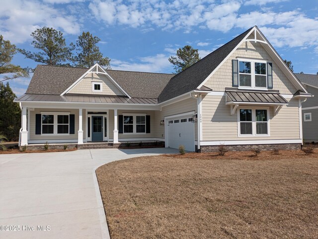 craftsman-style house featuring a garage and a front lawn