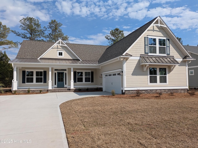 craftsman house with metal roof, covered porch, a garage, concrete driveway, and a standing seam roof