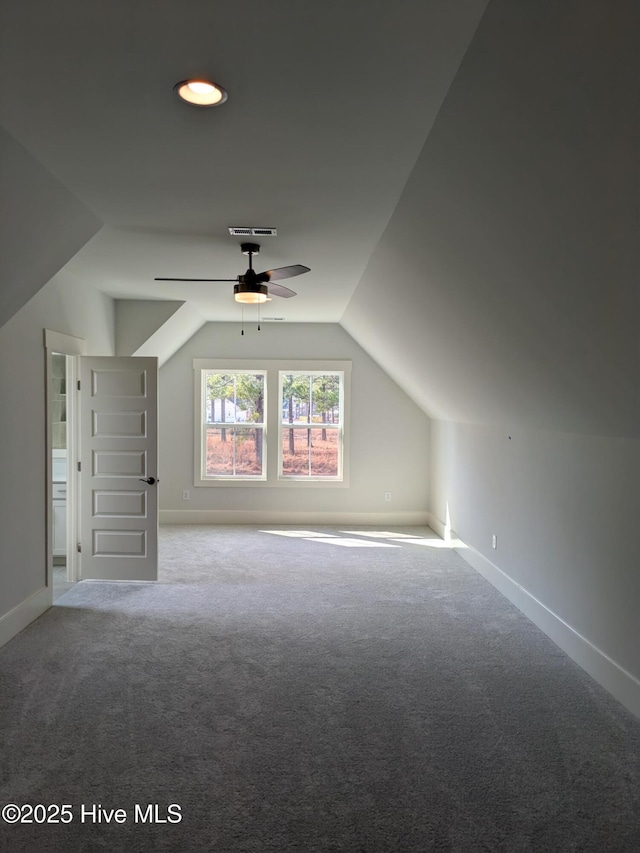 bonus room with ceiling fan, carpet flooring, visible vents, baseboards, and vaulted ceiling