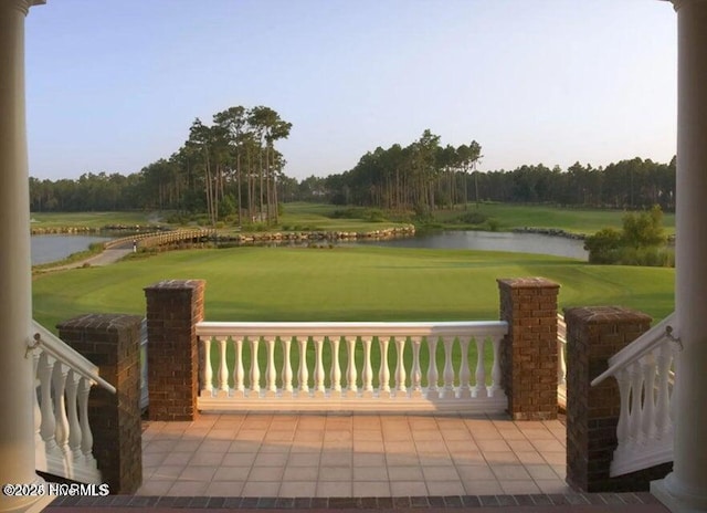 exterior space with a water view, a lawn, and golf course view