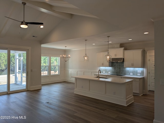 kitchen with dark wood-style flooring, light countertops, a sink, and white cabinetry