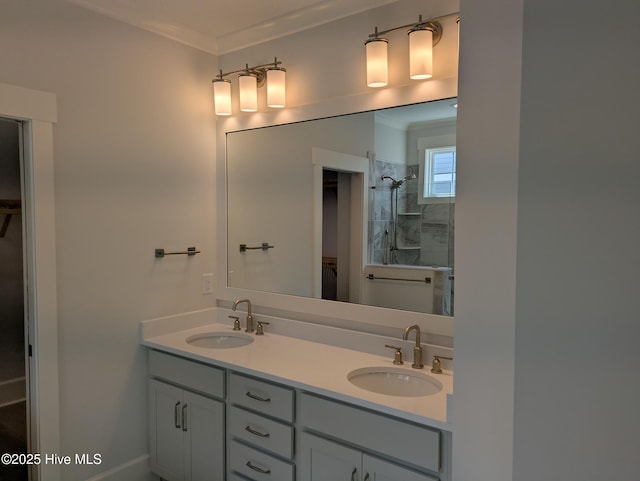 bathroom featuring a walk in closet, a sink, a tile shower, and double vanity