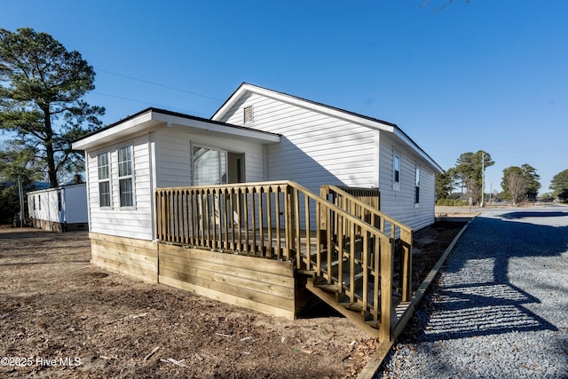 rear view of house featuring gravel driveway