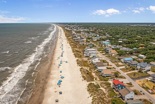 bird's eye view with a water view and a beach view