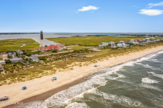 drone / aerial view with a water view and a beach view