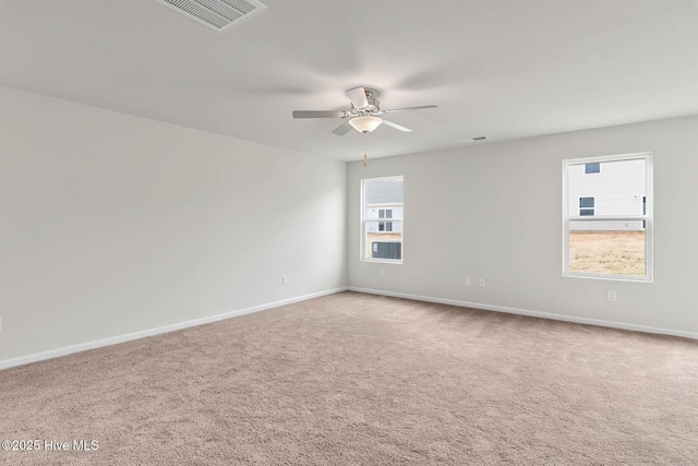 carpeted spare room featuring ceiling fan