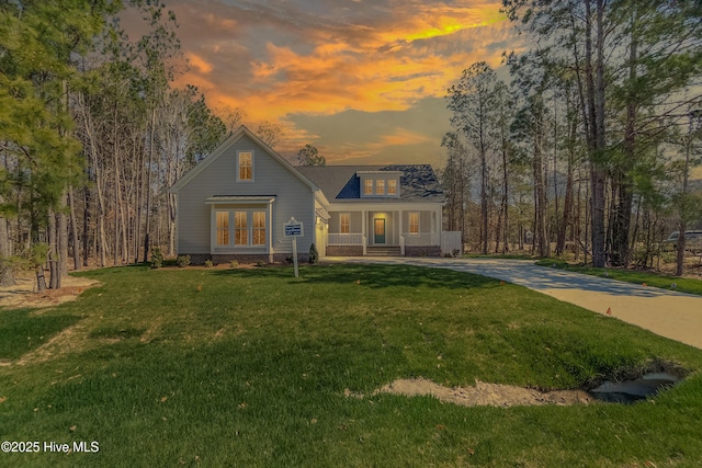 view of front of home with a yard and a porch