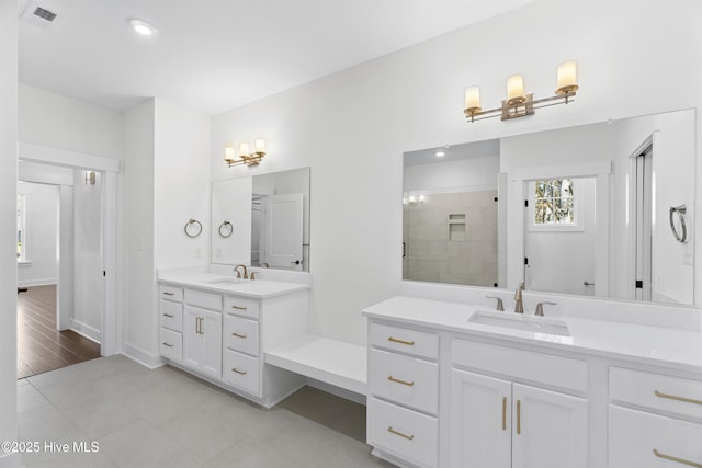 bathroom featuring walk in shower and vanity