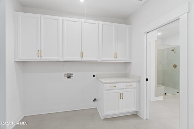 clothes washing area with washer hookup, cabinets, and electric dryer hookup