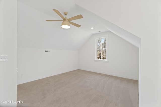 bonus room with ceiling fan, light colored carpet, and lofted ceiling