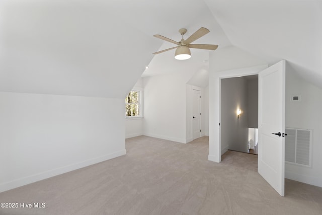 bonus room with light carpet, ceiling fan, and vaulted ceiling