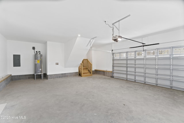 garage featuring water heater, a garage door opener, and electric panel