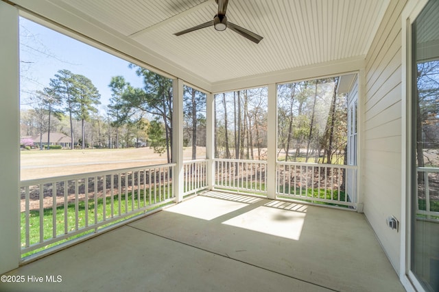 unfurnished sunroom with ceiling fan