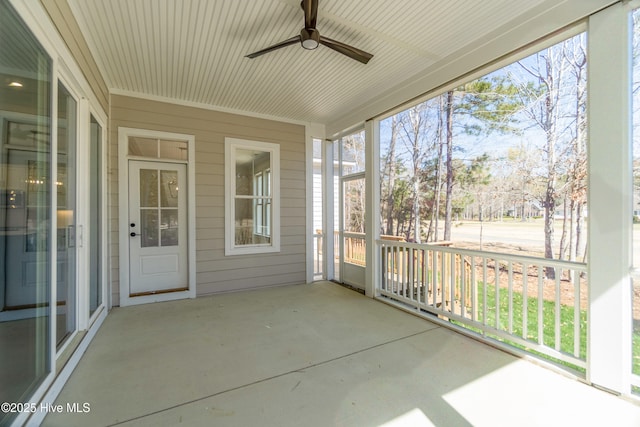 unfurnished sunroom with ceiling fan