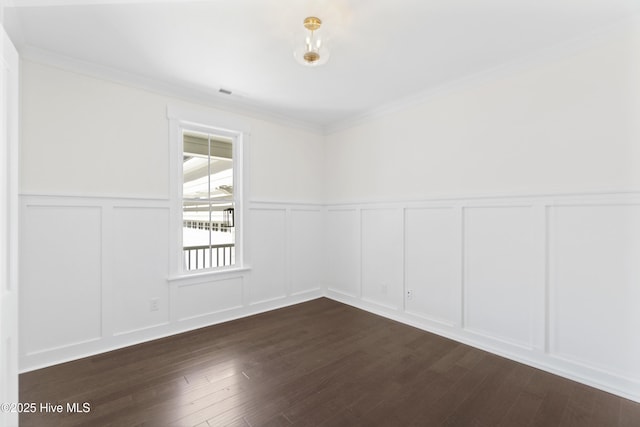 unfurnished room featuring dark hardwood / wood-style flooring and ornamental molding