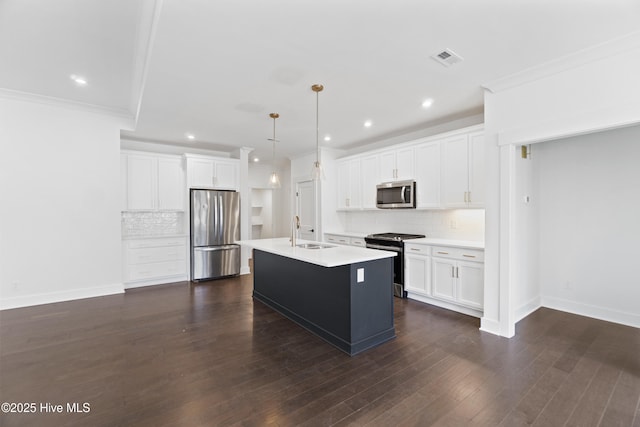 kitchen featuring white cabinetry, stainless steel appliances, a kitchen island with sink, hanging light fixtures, and sink