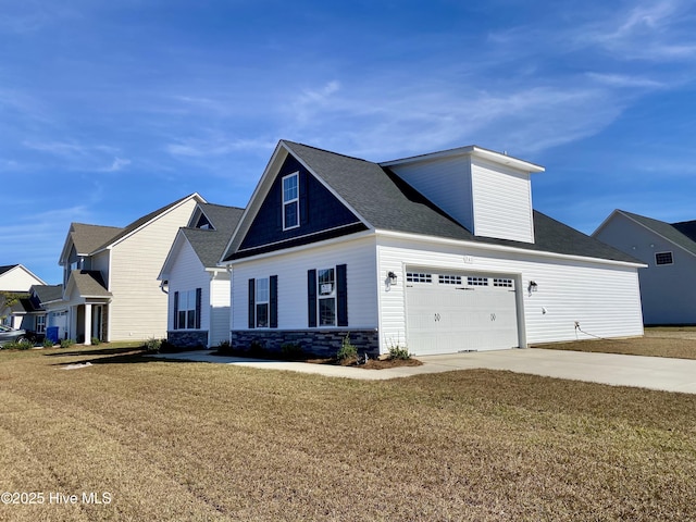 view of front of house with a garage and a front yard