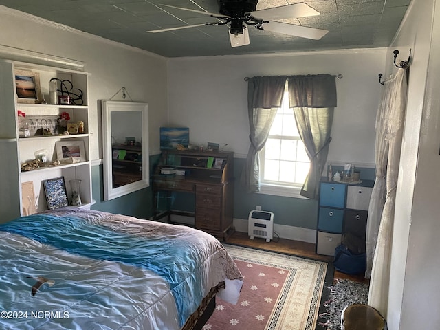 bedroom featuring ceiling fan, wood-type flooring, and crown molding