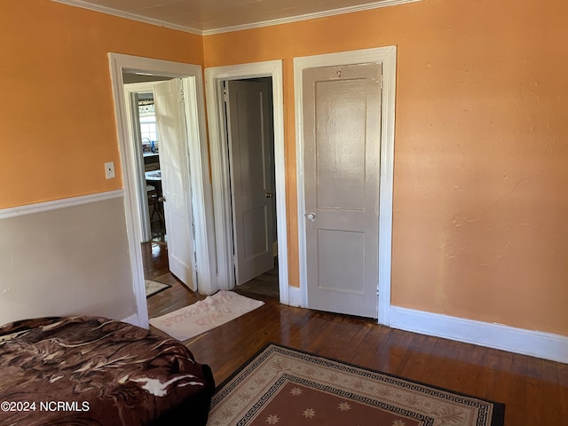 bedroom featuring ornamental molding and hardwood / wood-style flooring