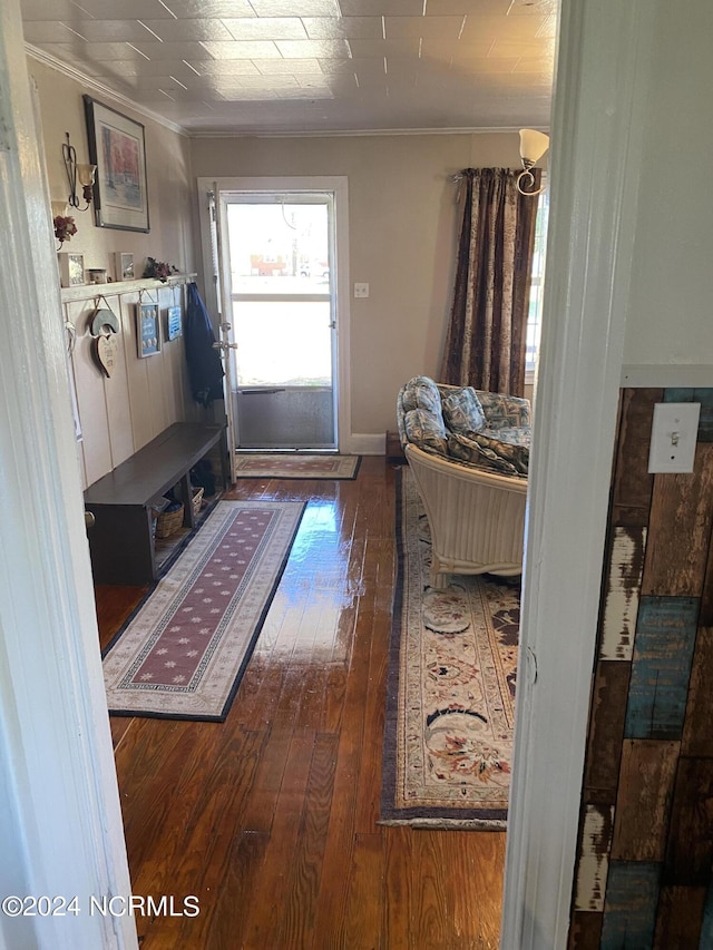 mudroom with ornamental molding and dark hardwood / wood-style floors