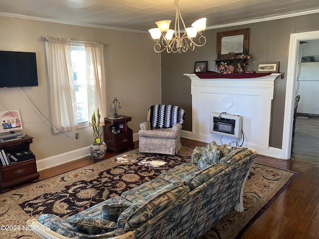 living room featuring dark hardwood / wood-style floors, heating unit, crown molding, and an inviting chandelier