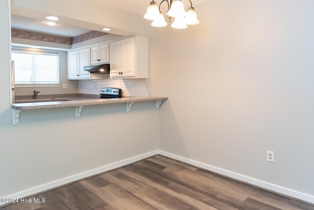 kitchen with decorative light fixtures, white cabinetry, kitchen peninsula, a notable chandelier, and a breakfast bar