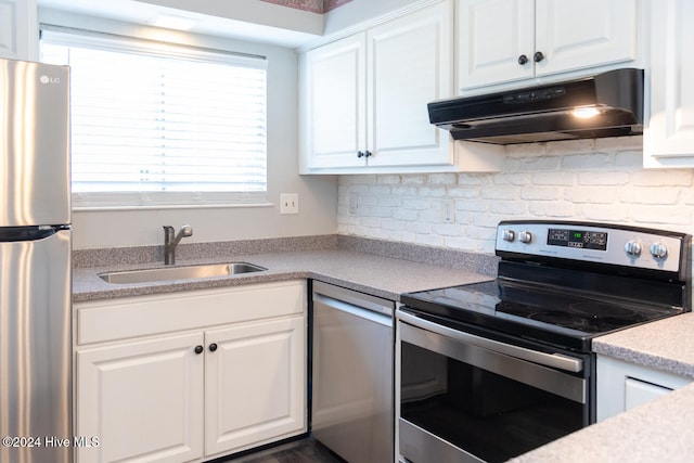 kitchen with appliances with stainless steel finishes, white cabinets, and sink