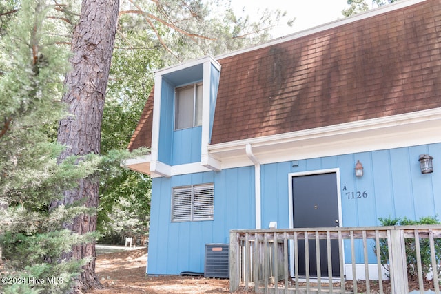 rear view of house featuring central AC unit