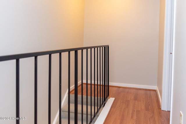 staircase with hardwood / wood-style floors