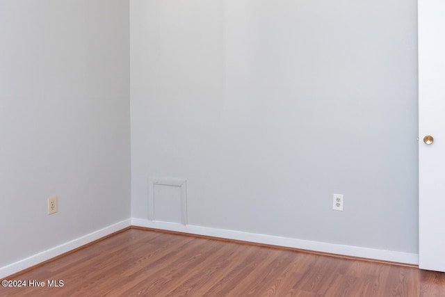 unfurnished room with wood-type flooring