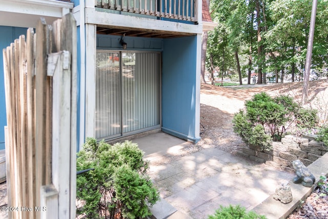 view of exterior entry featuring a balcony