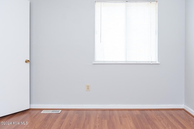 unfurnished room with hardwood / wood-style floors