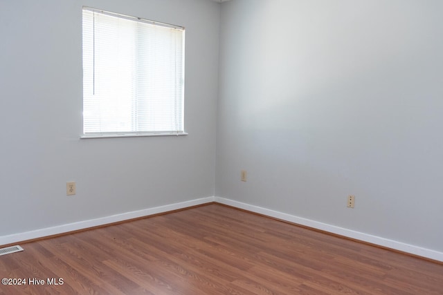 unfurnished room featuring hardwood / wood-style flooring