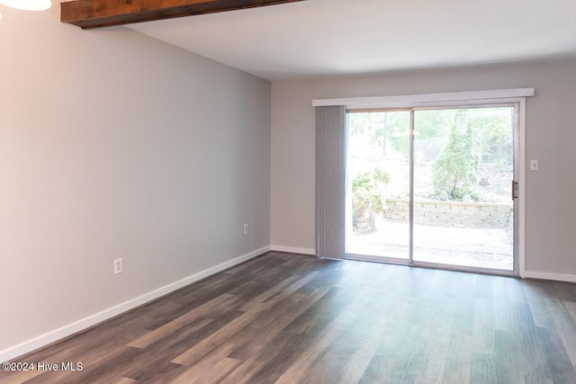 unfurnished room featuring beam ceiling and dark hardwood / wood-style flooring