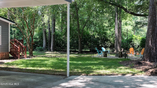 view of yard featuring a patio area and an outdoor fire pit