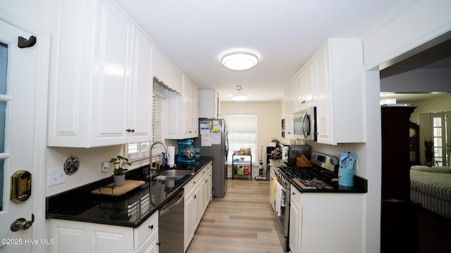 kitchen featuring light hardwood / wood-style floors, sink, white cabinetry, and stainless steel appliances